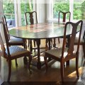 F19. Gateleg dining table (30"h x 78"w x 60"d) and 6 Queen Anne dining chairs. 